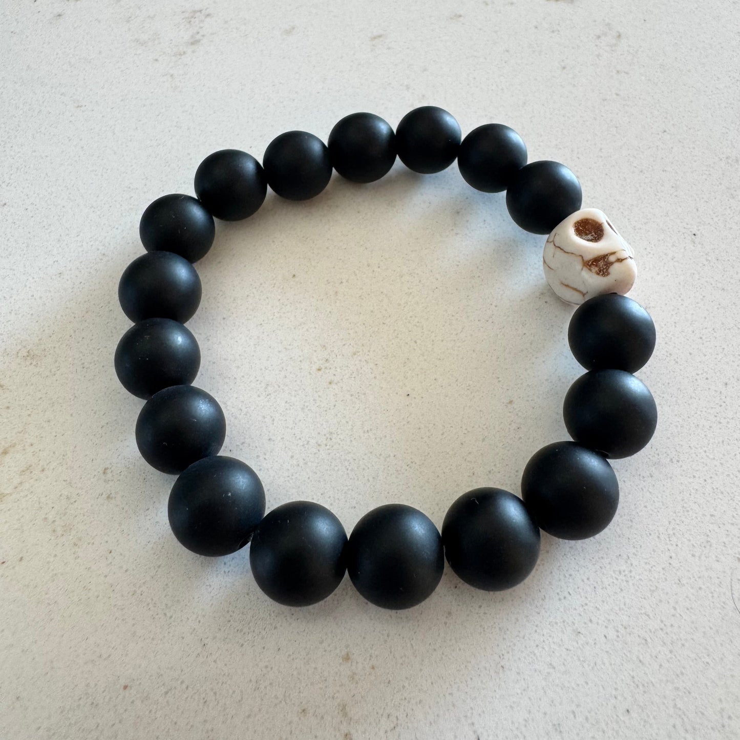 10mm Matte Black Onyx Gemstone Bead Stretch Bracelet with White Skull Accent Bead