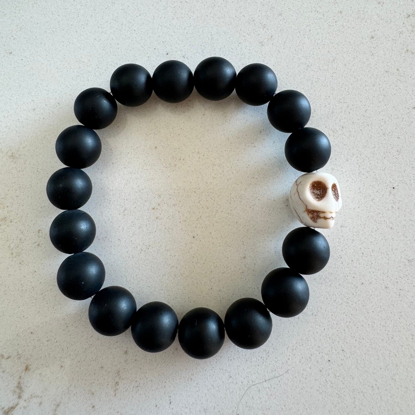 10mm Matte Black Onyx Gemstone Bead Stretch Bracelet with White Skull Accent Bead
