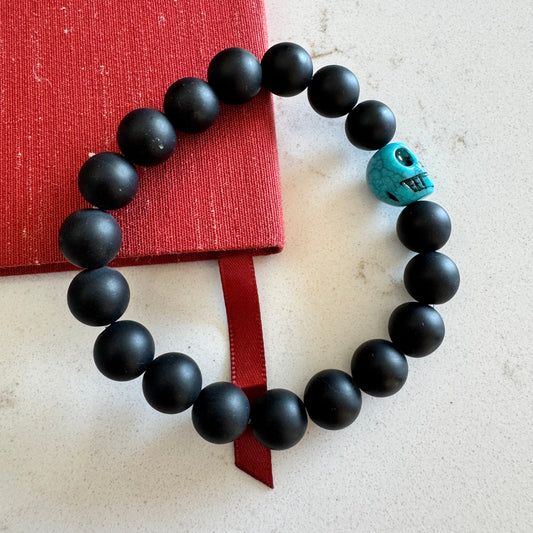 10mm Matte Black Onyx Gemstone Bead Stretch Bracelet with Blue Skull Accent Bead