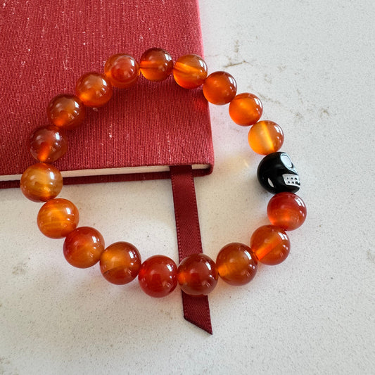 10mm Orange Carnelian Agate Gemstone Bead Stretch Bracelet With Black Skull Accent Bead
